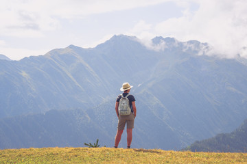 Woman hiker admiring misty mountains, Svaneti national park, Georgia