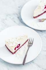 Piece of raw coconut vanilla cake with raspberries on white background. Sugar, dairy and gluten free dessert. Food photography concept. 