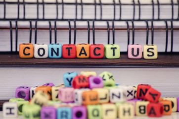 Business and customer support concept, cube dices with word Contact Us. Selective focus and shallow depth of field