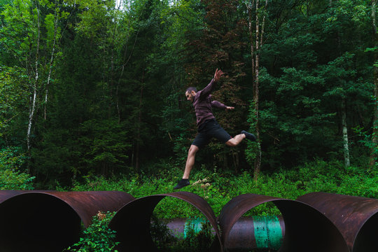 Man jumping on huge tube