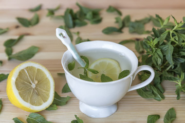 Hot mint lemon tea prepared in porcelain plate
