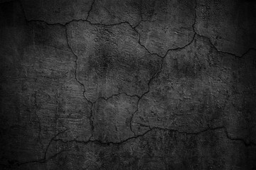 Black cement wall. Dark texture of cracked concrete