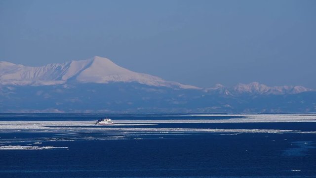 知床連峰と流氷砕氷船おーろら
