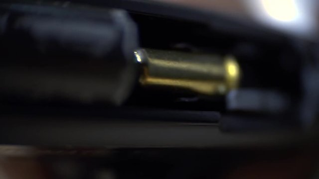 Macro as the trigger of the pistol is pulled and inside is the bullet