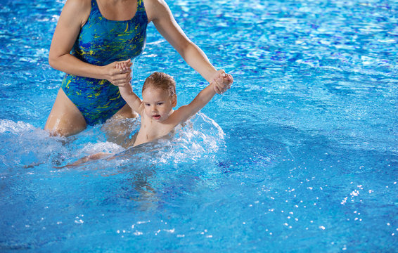 Young woman and little son in swimming pool