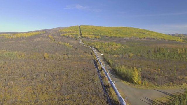 Aerial footage of the Alaska oil pipeline in the fall season 