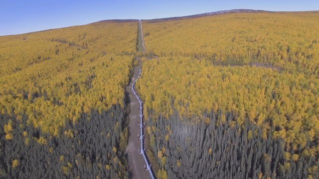 Aerial footage of the Alaska oil pipeline in the fall season 