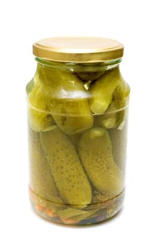 glass jar with pickled cucumbers isolated on white background