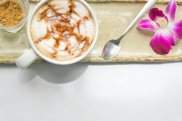 Closeup top view hot coffee latte on table with light of sun at morning, happy feelling