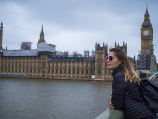 Fototapeta na wymiar Young blonde girl in London - Westminster Bridge and Houses of Parliament