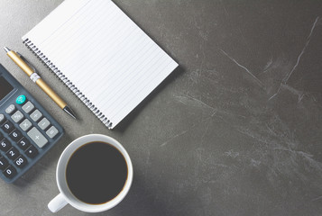 Top view office table with paper and coffee and calculator and pen for business and copy space.