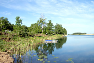 Summer landscape with river and cloudy sky