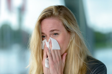 Young blond woman with hay fever
