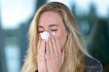 Young blond woman with hay fever