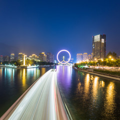Fototapeta na wymiar Tianjin Hai river waterfront downtown skyline with big ferris wheel named 