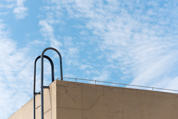 Ladder leading to the roof of a building against blue sky in China