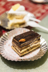Chocolate layer cake topping with almond at cafe in winter in Darjeeling, India.