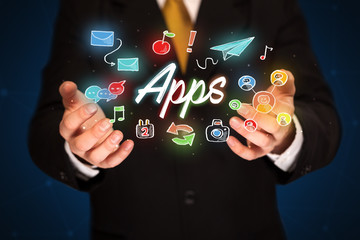 Businessman holding apps