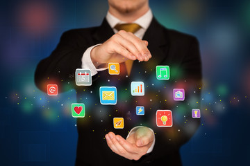 Businessman holding application icons