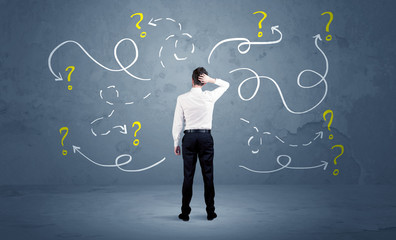 Unsure businessman with question marks