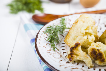 Fried cauliflower on a wooden table.