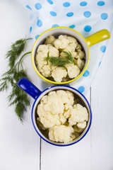 Boiled cauliflower in multi-colored bowls