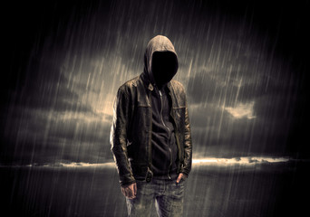 Anonymous terrorist in hoodie at night