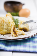 Fried cauliflower on a wooden table.
