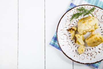 Fried cauliflower on a wooden table.