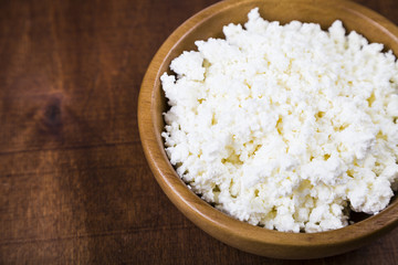 Cottage cheese in a wooden bowl