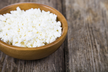 Cottage cheese in a wooden bowl
