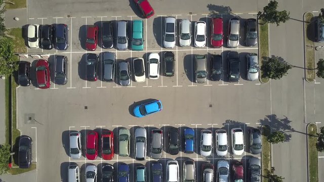 AERIAL TOP DOWN, HYPERLAPSE: Bad driver incapable to park a car on parking space in big crowded parking lot. Female having problems, unable to park a car in parking spot. Parking fail on parkspace