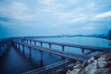 Obraz na płótnie Canvas Dalian Cross-Sea Bridge against cloudy sky,China.