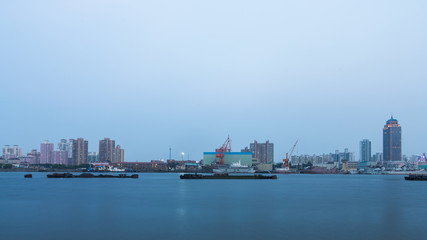 Fototapeta na wymiar Ships on Huangpu River and cranes at the harbour,shanghai,china.