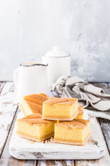 Traditional homemade baked pudding cake on old white wooden cutting board. Healthy dessert. Product photography for patisserie or restaurant.