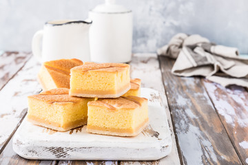 Traditional homemade baked pudding cake on old white wooden cutting board. Healthy dessert. Product photography for patisserie or restaurant.