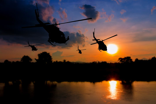 soldier silhouette in rappelling climb down from helicopter on sunset with copy space add text