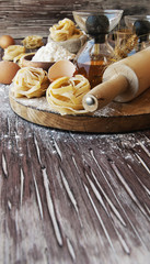 Uncooked pasta with flour on the table, selective focus