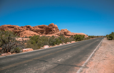 Fototapeta na wymiar Road and rocks in the desert Moab. Arches National Park
