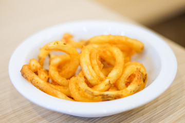Hot french fries serve on white plate for food background or texture - Fast Food concept.