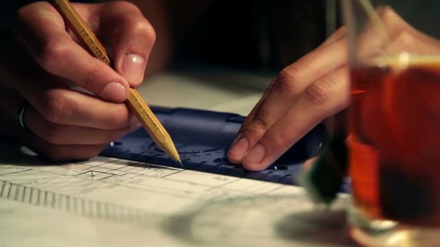 Draftsman draws and drinks tea