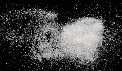White crystal sugar pile isolated on black background and texture, top view