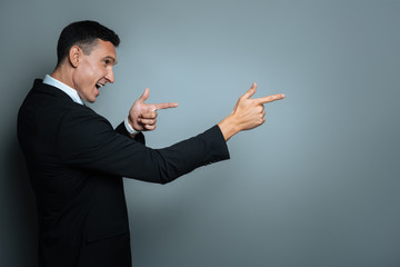 Happy joyful man pointing in front of him