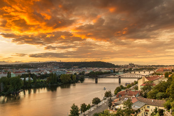 Fototapeta na wymiar Prague sunset over Vltava river from above with orange sky.