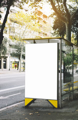 Blank advertising light box on bus stop, mockup of empty ad billboard on sun day bus station, template banner on background city street for poster or sign in Barcelona, afisha board and taxi cars.