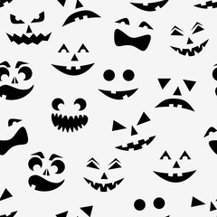 Seamless pattern with black halloween pumpkins carved faces silhouettes on white background.
