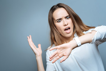 Shocked pretty woman looking at her watch