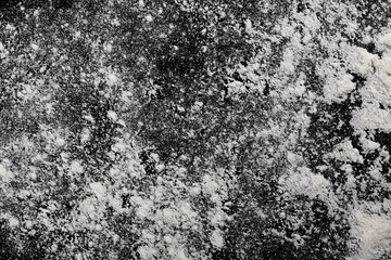 Pile of wheat flour isolated on black background, powder texture, top view with clipping path