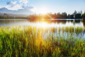 The sunrise over a lake in the park High Tatras. Shtrbske Pleso, Slovakia