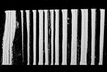 Cocaine lines isolated on black background 